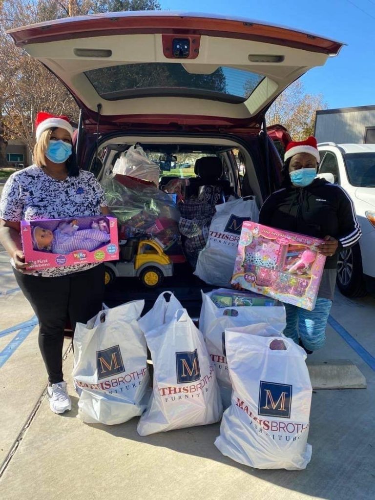 Sistas Making a Difference pose with toys for the Sistas' holiday toy drive