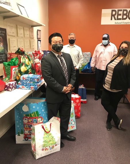 San Bernardino County Public Defenders and Inland Empire Rebound pose with toys for the annual Angel Tree Toy Giveaway