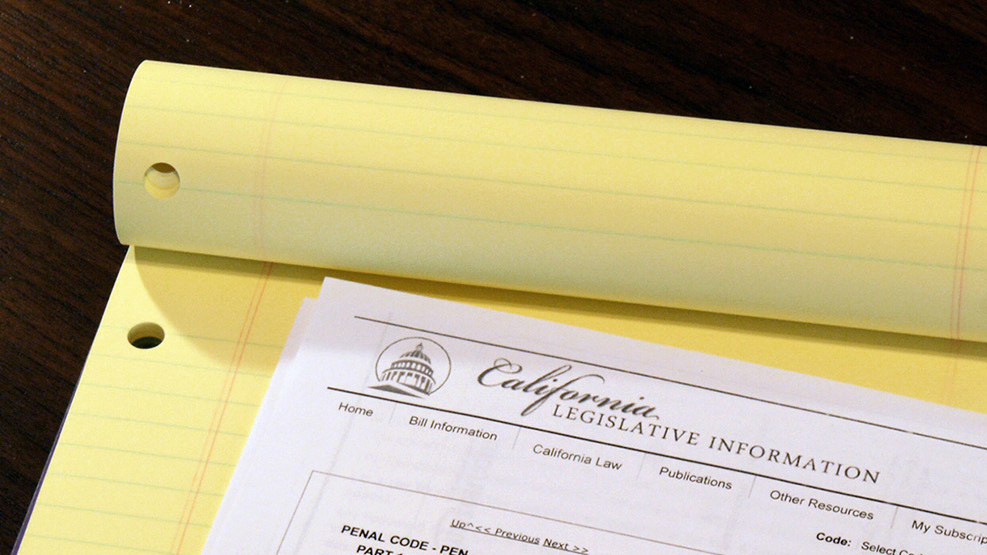 A paper copy of California PC 290 atop a yellow legal pad