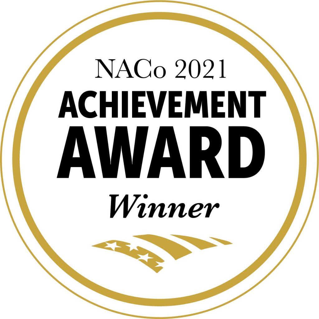 Graphic with black text reading NACo 2021 Achievement Award Winner inside a gold circle