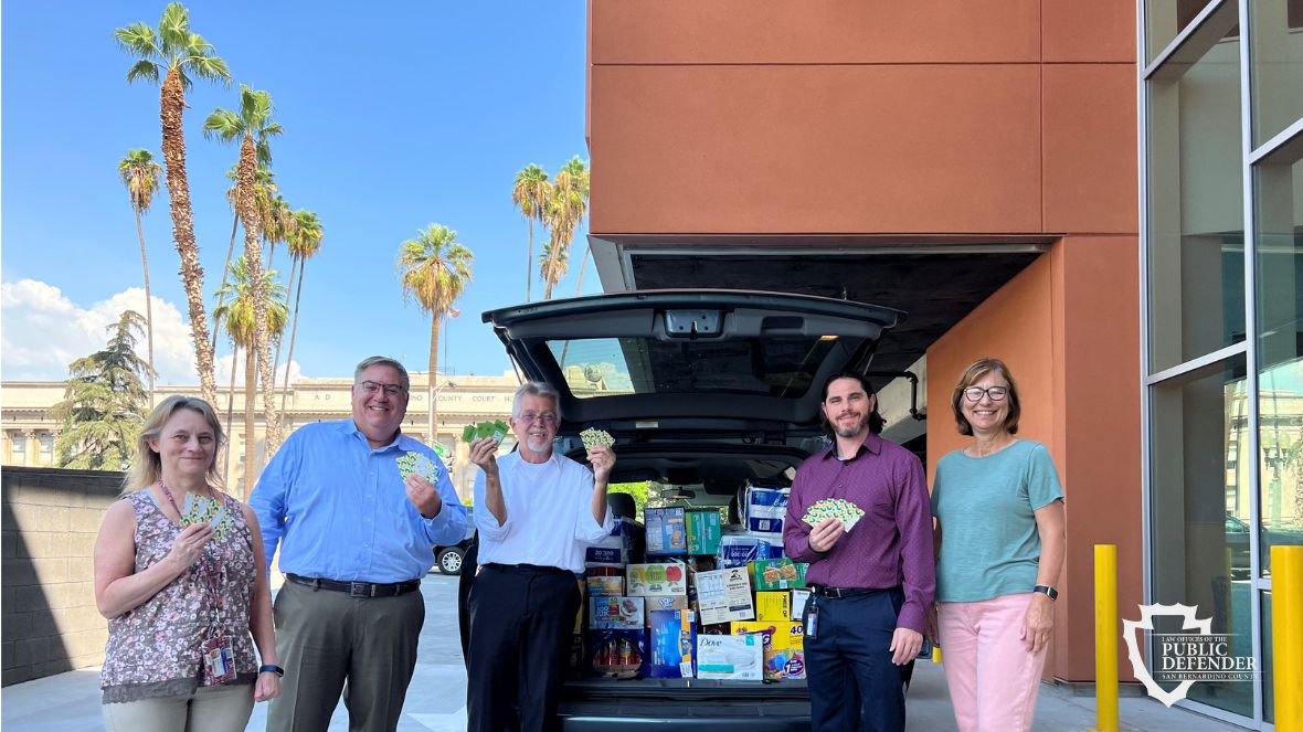 Public Defender staff standing in front of SUV filled with donations to YouthHope September 6 2022.