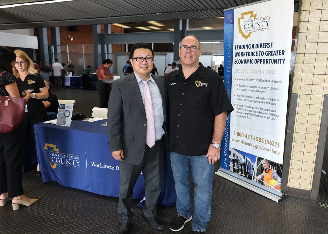 Public Defender Thomas W. Sone and San Bernardino County Supervisor Curt Hagman posing in front of job fair.