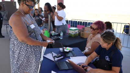 Woman being assisted by Public Defender staff to register for Mobile Defense event.