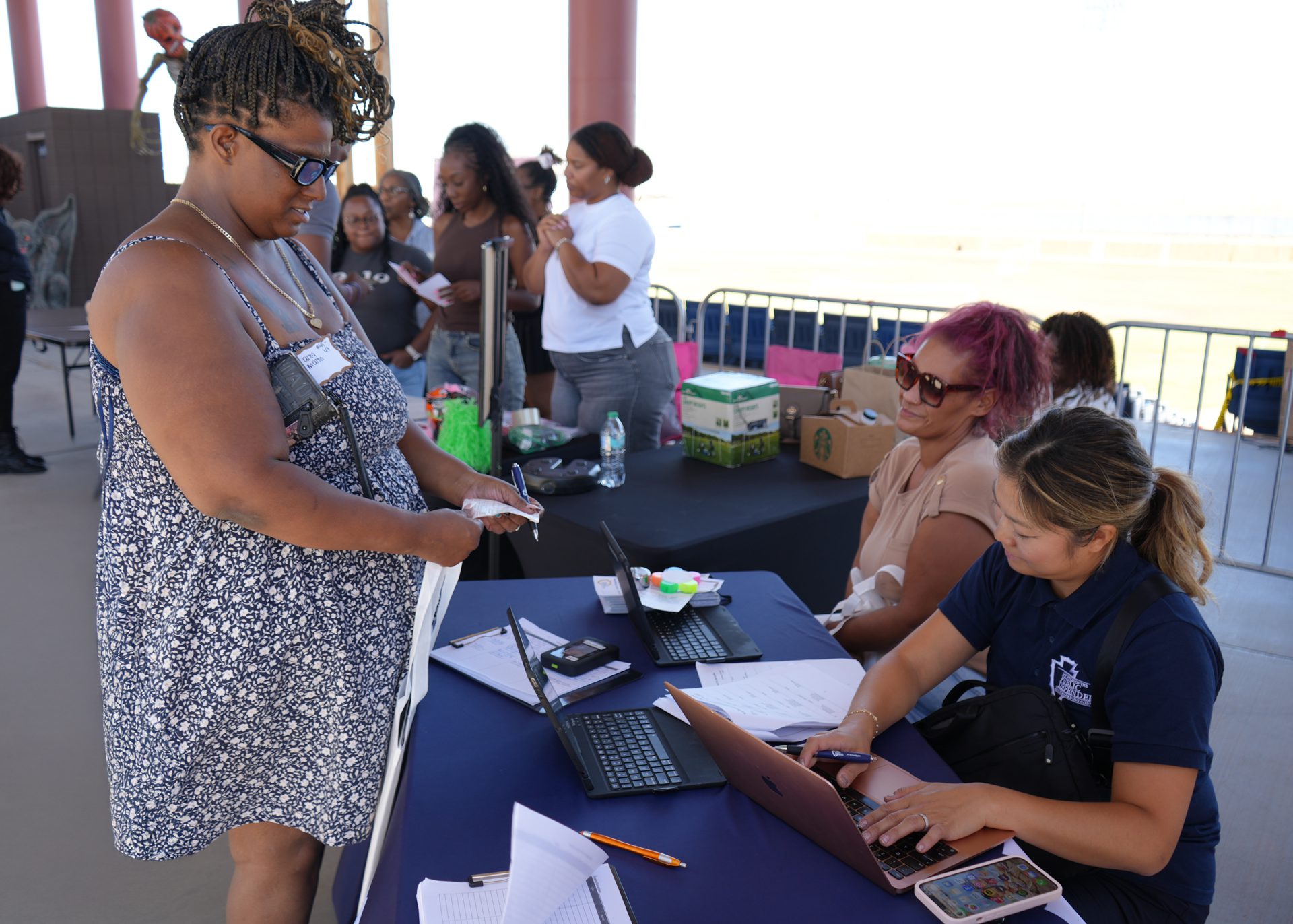 Woman being assisted by Public Defender staff to register for Mobile Defense event.