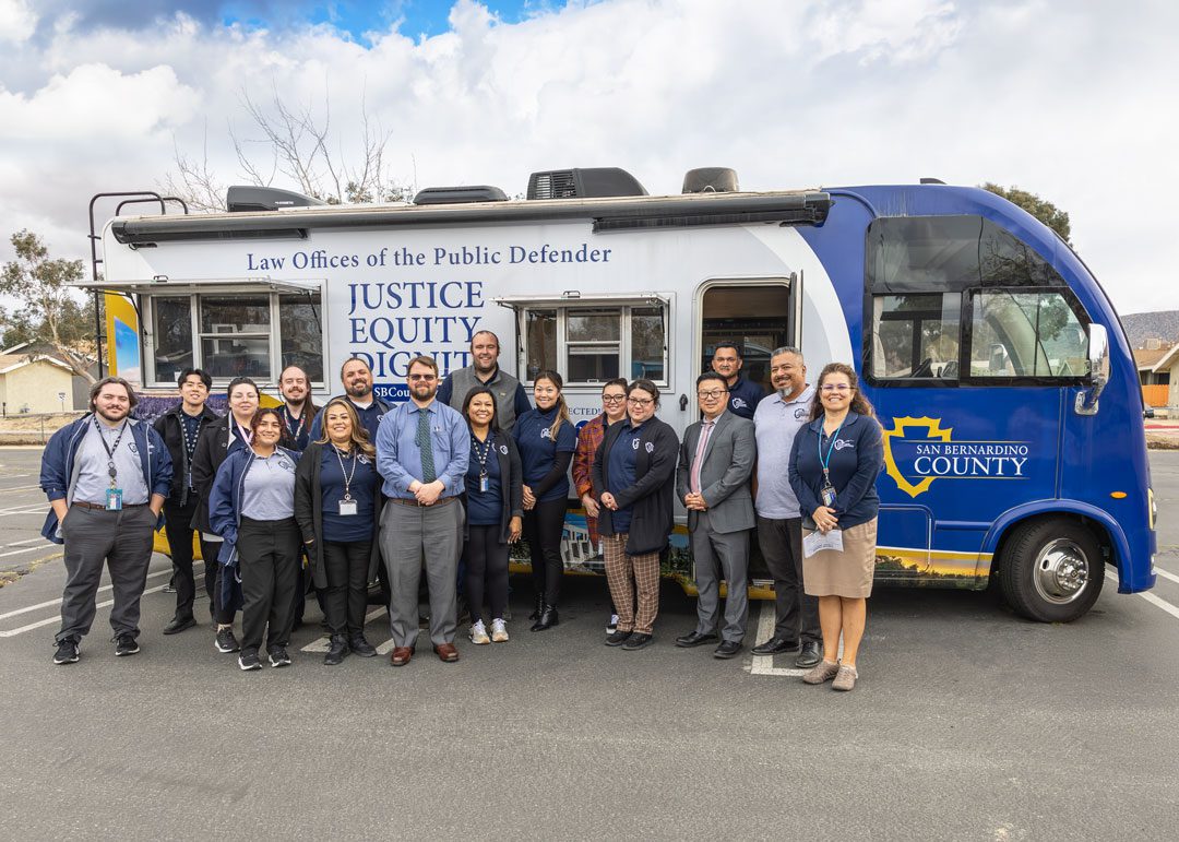 Public Defender staff stand in front of the Mobile Defense mobile unit at the Joshua Tree Community Center.