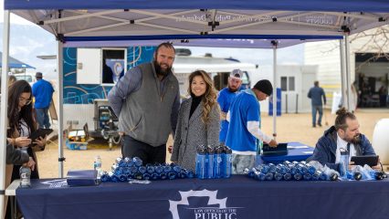 Public Defender staff host outreach booth under canopy, sharing resources at Mobile Defense event at The River’s Edge Ranch.
